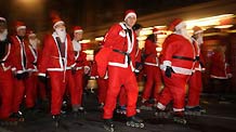 Roller skaters dressed as Santa Clause skate along the streets during the Santa Skate in London, capital of Britain, on December 19, 2009.