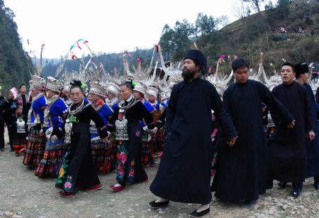 People of the Miao ethnic group perform traditional dance during the closing celebration of the Guzang Festival at Wuliu Village in Leishan County, southwest China&apos;s Guizhou Province, December 19, 2009.