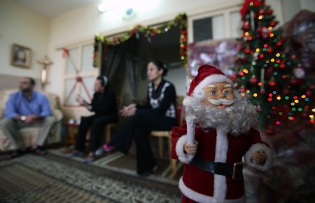 Soad al-Massri, 57-year-old Palestinian Christian, sit with her family at their house in Gaza City December 22, 2009