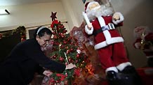 Soad al-Massri, 57-year-old Palestinian Christian, decorates Christmas tree at her house in Gaza City December 22, 2009.