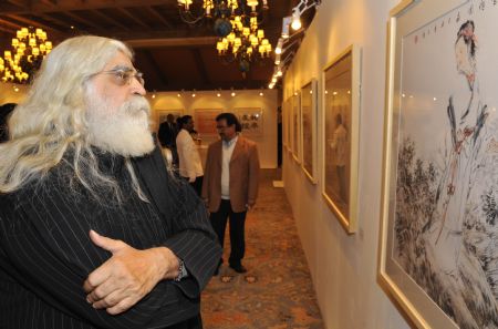 A visitor watches a Chinese ink painting work during the exhibition 'Spotlight on Chinese Ink Painting: International Art Exhibition in India' at Hotel Taj Mahal in New Delhi, capital of India, December 23, 2009.