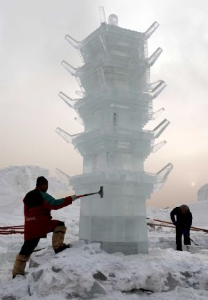 Technicians from Harbin, northeast China's Heilongjiang Province, work on an ice sculpture in Hexigten Qi in north China's Inner Mongolia Autonomous Region, December 25, 2009.