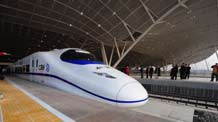 A high-speed train runs in Xianning city, central China's Hubei Province, December 26, 2009. The Wuhan-Guangzhou high-speed railway, which boasts of the world's fastest train journey with a 350-km-per-hour average speed, is debuted on Saturday.