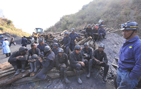 Miners wait after the coal mine accident at Malishu Coal Mine in Shuangbai County, Chuxiong Yi Autonomous Prefecture, southwest China's Yunnan Province, December 28, 2009.