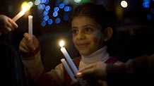 A Palestinian girl takes part in a candle-lighting protest in solidarity with Gaza, in the West Bank city of Ramallah, on December 27, 2009.