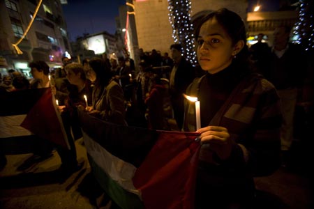 Palestinians take part in a candle-lighting protest in solidarity with Gaza, in the West Bank city of Ramallah, on December 27, 2009. 