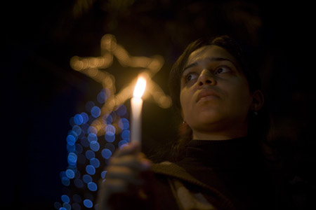 A Palestinian girl takes part in a candle-lighting protest in solidarity with Gaza, in the West Bank city of Ramallah, on December 27, 2009. 