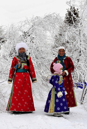People of Mongolian ethnic group pose for photos in Xi Ujimqin Qi, north China's Inner Mongolia Autonomous Region, on December 28, 2009.