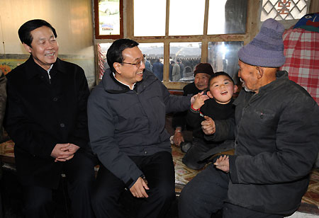 Chinese Vice Premier Li Keqiang (L2) talks with 83-year-old Meng Pin and his family in Yingfanggou Village of Datong, north China's Shanxi Province, December 27, 2009. Li Keqiang made an inspection tour in Shanxi from December 27 to 28. 
