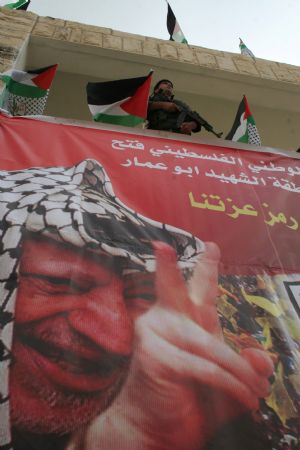 A Palestinian policeman guards during a rally to celebrate the 50th Anniversary of the founding of the Fatah movement in the West Bank city of Jenin, on December 29, 2009.