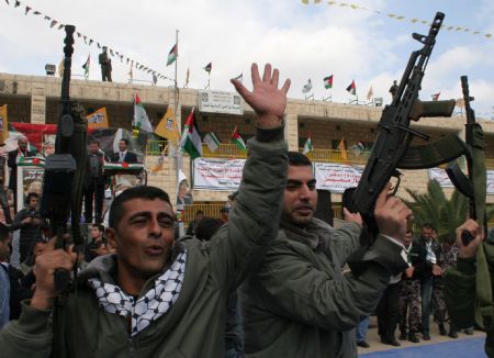 Palestinian policemen take part in a rally to celebrate the 50th Anniversary of the founding of the Fatah movement in the West Bank city of Jenin, on Dec. 29, 2009.(Xinhua/Ayman Nobani)