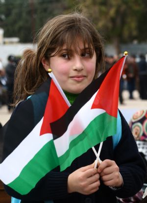 A Palestinian girl takes part in a rally to celebrate the 50th Anniversary of the founding of the Fatah movement in the West Bank city of Jenin, on December 29, 2009. 