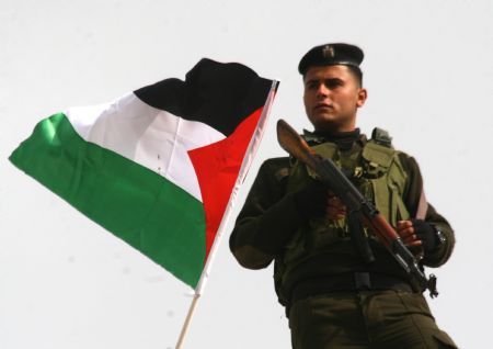 A Palestinian policeman guards during a rally to celebrate the 50th Anniversary of the founding of the Fatah movement in the West Bank city of Jenin, on December 29, 2009.