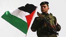 A Palestinian policeman guards during a rally to celebrate the 50th Anniversary of the founding of the Fatah movement in the West Bank city of Jenin, on December 29, 2009.