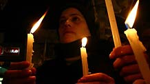 Palestinians hold candles to mark the one-year anniversary of Israeli offensive on the Gaza Strip, in the West Bank city of Nablus, on January 2, 2010.