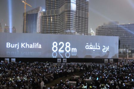 The height of the Burj Khalifa tower is shown on a screen during its opening ceremony in Dubai, the United Arab Emirates, January 4, 2010. 