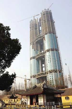 The new skyscraper being constructed in Huaxi Village, east China's Jiangsu Province, exceeds 250 meters in height on Tuesday, January 5, 2010. It is scheduled to be completed this June.