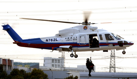 A helicopter belonging to China Shanghai rescue team is on a rescue operation drilling in Shanghai January 7, 2010. 