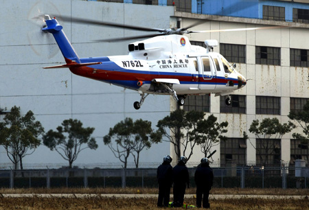 A helicopter belonging to China Shanghai rescue team is on a rescue operation drilling in Shanghai January 7, 2010. 