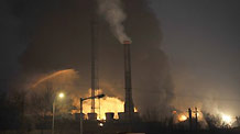 Picture taken on January 7, 2010 shows smoke and fire billowing from a factory in which an explosion occured in Lanzhou, capital of northwest China's Gansu Province.