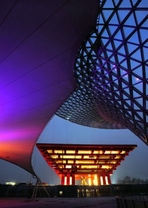 Photo taken on January 7, 2010 shows the brillant cable-membrane structure of the Expo Axis against the China Pavilion during a trial illumination in Shanghai, east China. 