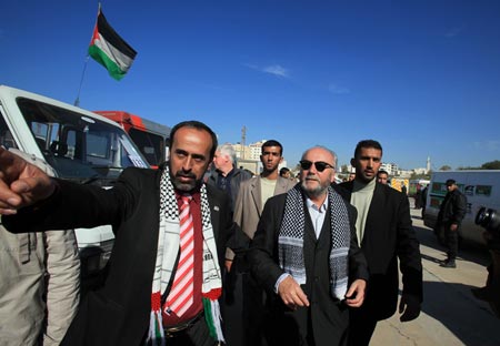 British MP George Galloway walks near aid convoy trucks carrying medical supplies in Gaza January 7, 2010. 