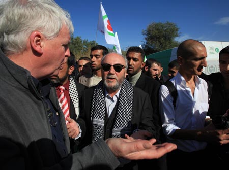 British MP George Galloway walks near aid convoy trucks carrying medical supplies in Gaza January 7, 2010. 