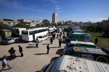 International peace activists stand next 153 trucks carrying medical supplies in Gaza, January 7, 2010.