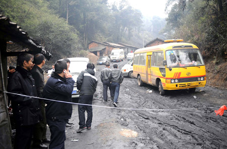 Police officers keep order at Miaoshang Coal Mine in Yushui District of Xinyu City, east China's Jiangxi Province, January 9, 2010. 