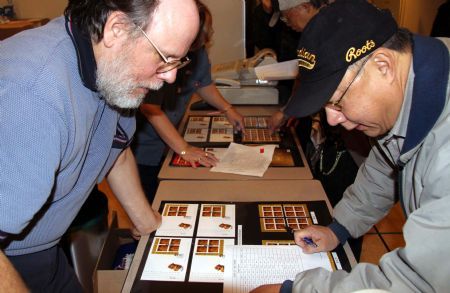 Overseas Chinese queue to buy newly issued tiger stamps during a reception to celebrate Canada Post's issuing a set of Year of the Tiger stamps to mark the upcoming Chinese lunar new year in Ottawa, Canada, January 8, 2010. 