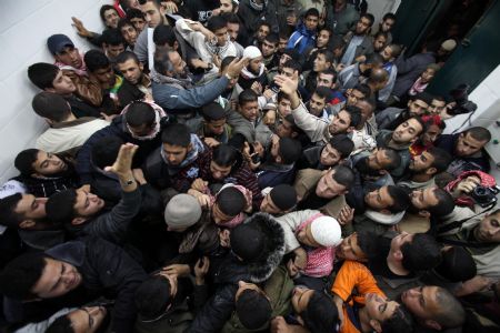 Palestinians mourn after three Gaza militants were killed in an Israeli missile strike, in the central Gaza town of Deir al-Balah, January 10, 2010.