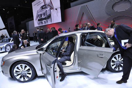 Visitors are attracted by an Audi A8 sedan during the media preview of the 2010 North American International Auto Show (NAIAS) at Cobo center in Detroit, Michigan, the United States, January 11, 2010. 