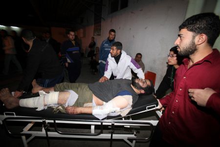 Palestinians carry the wounded at Kamal Adwan Hospital after an Israeli air strike in Beit Hanoun, northern Gaza Strip January 11, 2010.