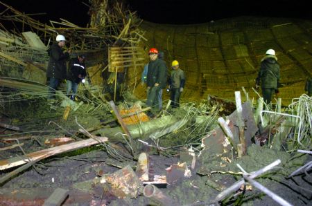 Rescuers work at the scene of a collapse accident at the construction site of Wuhu Huaqiang Culture and Technology Park in Wuhu, east China's Anhui Province, January 12, 2010.