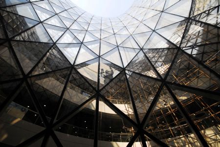 Photo taken on January 12, 2010 shows a worker cleaning the glass curtain of the Sunshine Valley located at the axle of the World Expo Garden in Shanghai, east China. 