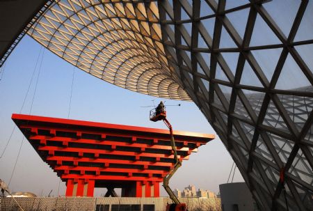 Photo taken on January 12, 2010 shows a worker cleaning glass curtain of the Sunshine Valley located at the axle of the World Expo Garden in Shanghai, east China.