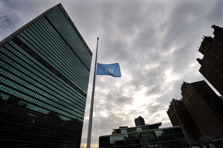 United Nations flag flies at half mast to mourn the victims of the Haiti earthquake in front of the UN headquarters in New York, January 13, 2010. 