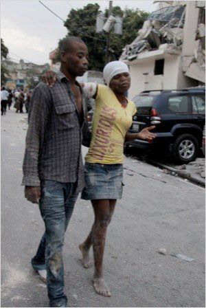 Two earthquake victims walk down the street of Haiti's capital Port-au-Prince on January 12, 2010. 