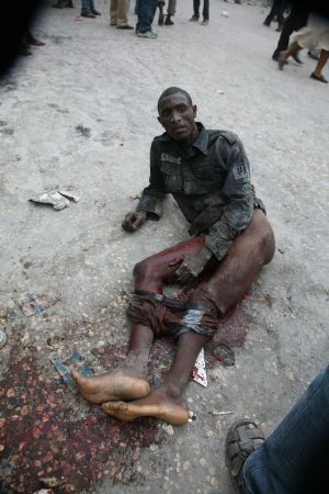 An injured person lies on the ground in Haiti's capital Port-au-Prince on January 12, 2010.