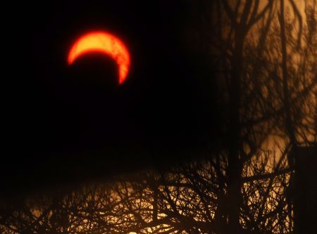 A sunset eclipse occurs in Taiyuan, capital of north China&apos;s Shanxi Province, Jan. 15, 2010.