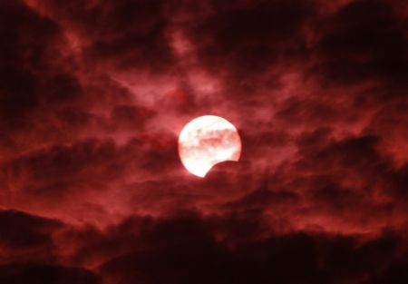 The moon passes between the sun and the earth during a partial solar eclipse in east China&apos;s Shanghai Municipality, Jan. 15, 2010. (Xinhua/Pei Xin) 