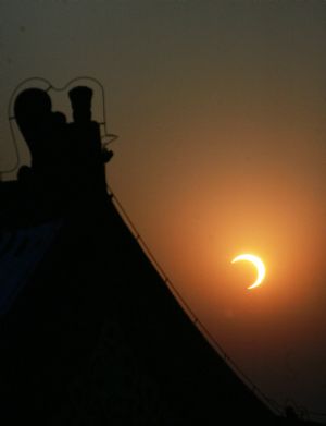 A partial eclipse is seen in this photo taken at the Temple of Heaven in Beijing, capital of China, Jan. 15, 2010. (Xinhua/Zheng Huansong)