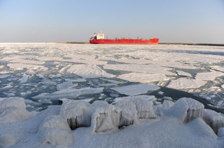 A vessel in berthed amid floating ice chunks in Laizhou Port of Laizhou City, east China's Shandong Province, Jan. 15, 2010. The worst sea ice in 30 years appeared from early January along the coastline of the Bohai Sea and the Yellow Sea as cold fronts pushed temperature to minus 10 degrees Celsius and below. By now over 40% of the sea surface of Bohai Sea has iced up.
