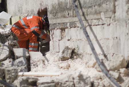 A British rescuer works on the debris in Port-au-Prince, capital of Haiti, Jan. 15, 2010.(Xinhua/David de la Paz)