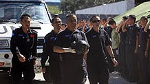 Chinese rescuers mourn as bodies of buried Chinese peacekeepers in Haiti are retrieved from ruins, in Port-au-Prince on January 16, 2010. Huang Jianfa, chief of the Chinese rescue team, said to Xinhua that all eight buried Chinese staff were confirmed dead.