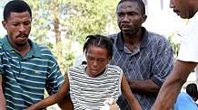 An injured woman is carried out of a hospital in Port-au-Prince, capital of Haiti, on January 16, 2010. The hospital is full of the earthquake patients with insufficient medical care.