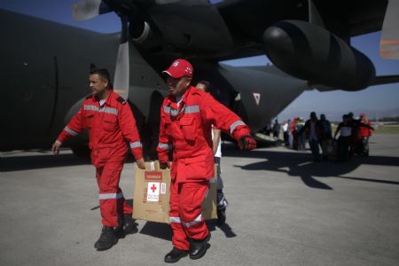Mexican rescuers unload relief goods from a cargo plane in Haitian capital Port-au-Prince on January 16, 2010. International rescuers are rushing to Haiti following a devastating earthquake on January 12.