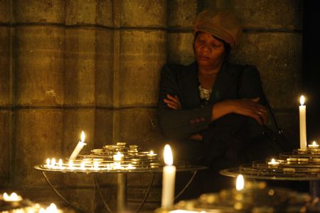 A woman attends a mass for the victims of the Haiti earthquake at the Notre Dame de Paris on January 16, 2010.