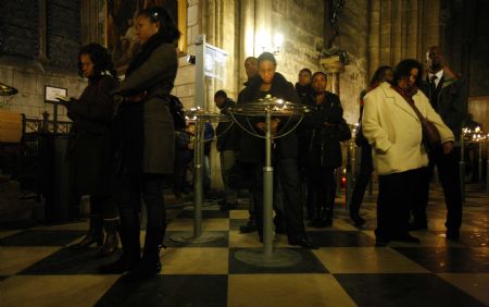People attend a mass for the victims of the Haiti earthquake at the Notre Dame de Paris on January 16, 2010. 