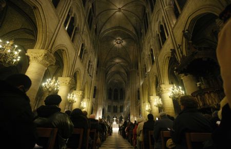 People attend a mass for the victims of the Haiti earthquake at the Notre Dame de Paris on January 16, 2010.